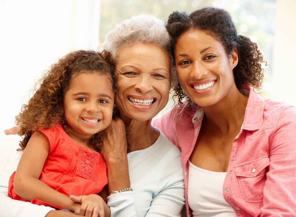 grandmother, daughter, and granddaughter smiling together and can rest assure they are covered with the grandmother's life insurance collinsville illinois