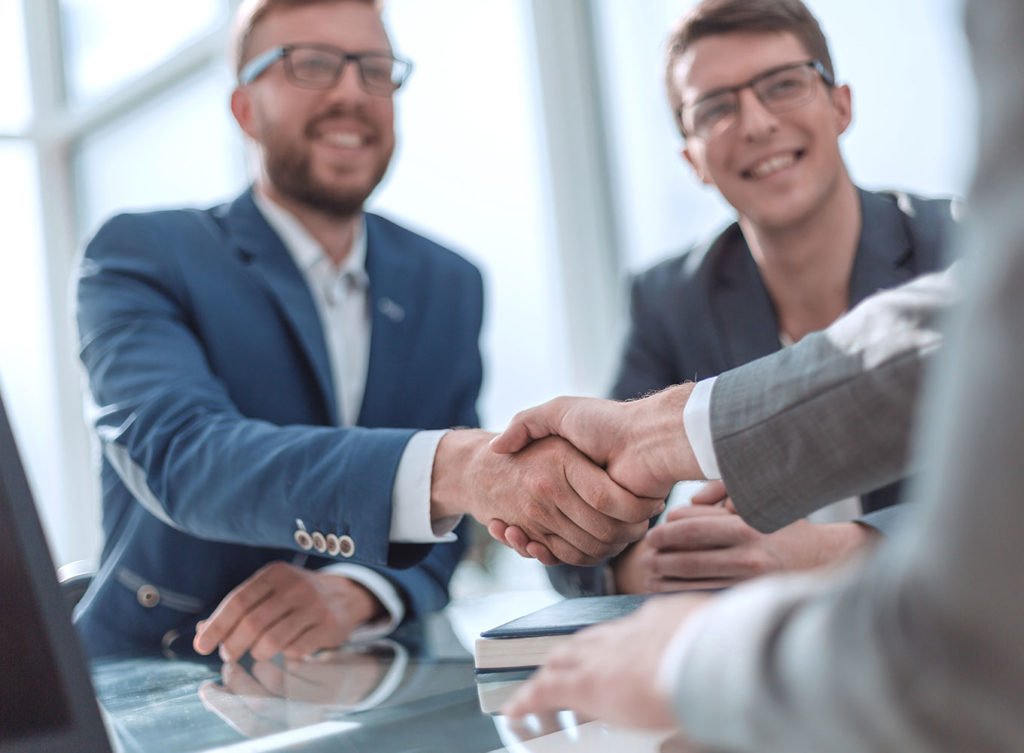 businessmen shaking hands with an business insurance agent in maryville illinois